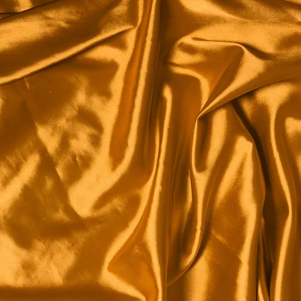 Hladké elegantní zlaté hedvábné pozadí — Stock fotografie