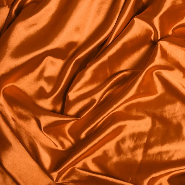 พื้นหลังผ้าไหมสีส้มเรียบหรู — ภาพถ่ายสต็อก