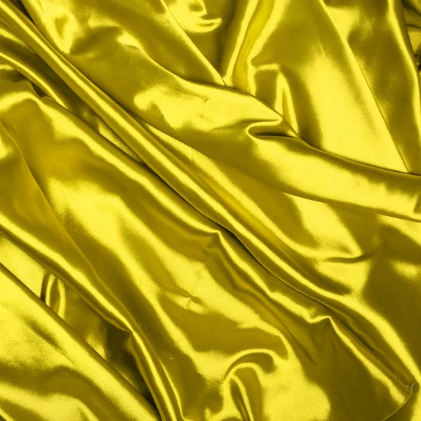 Hladké elegantní žluté hedvábné pozadí — Stock fotografie
