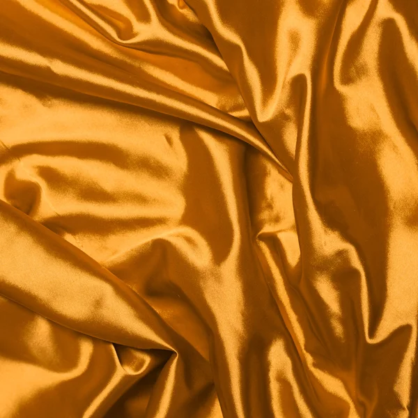 Smooth elegant gold silk background Royalty Free Stock Images