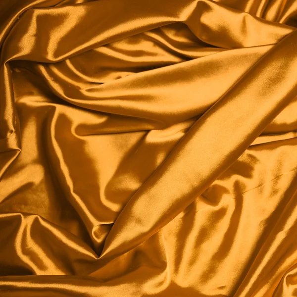 Smooth elegant gold silk background Stock Image