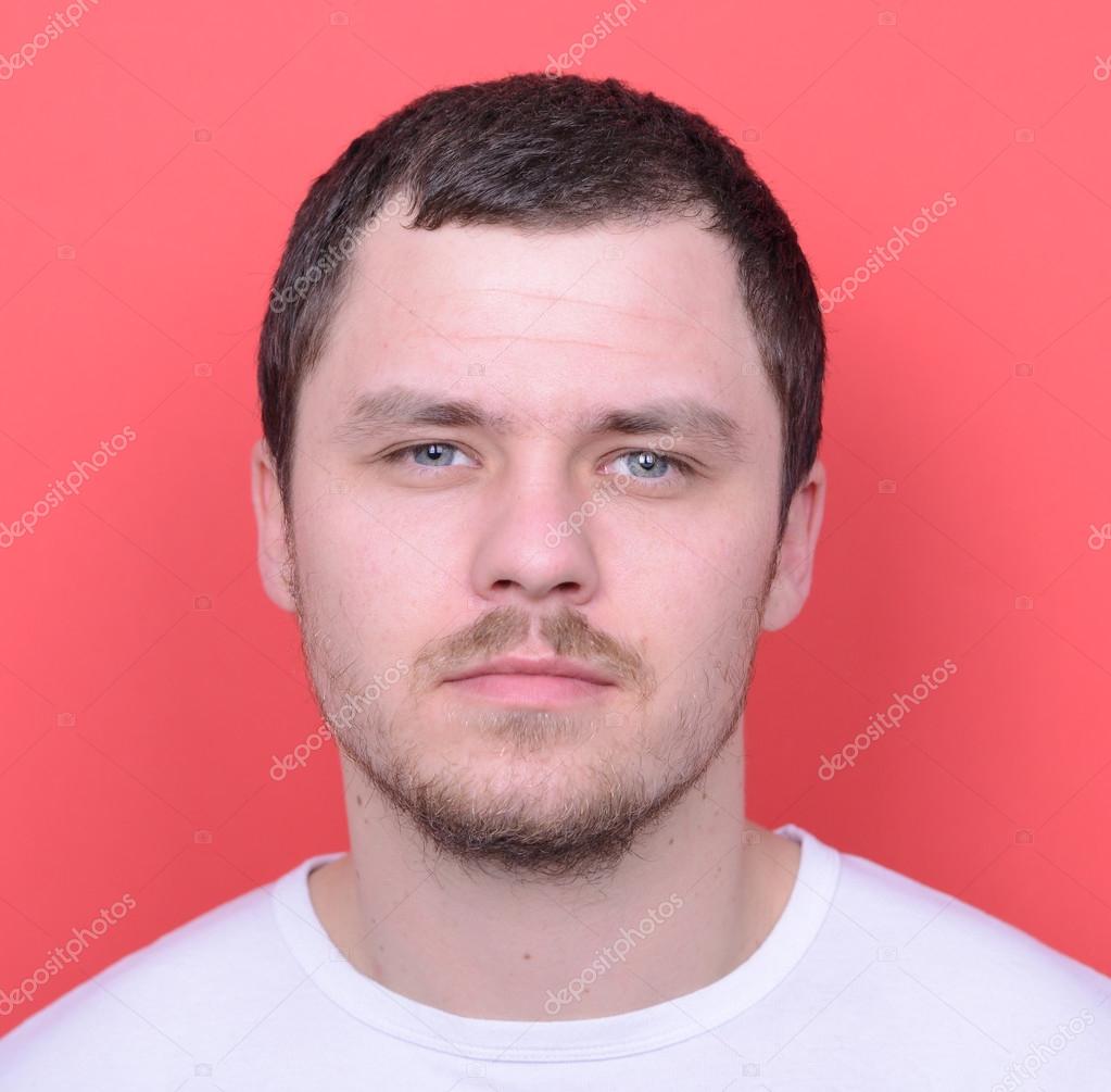 Portrait of handsome man in casual clothes against red backgroun