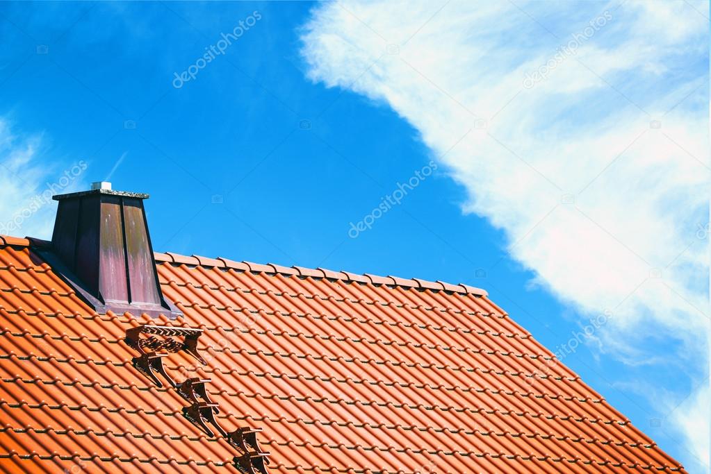 House roof against bright blue sky