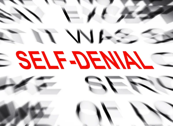 Texte flou mettant l'accent sur SELF DENIAL — Photo