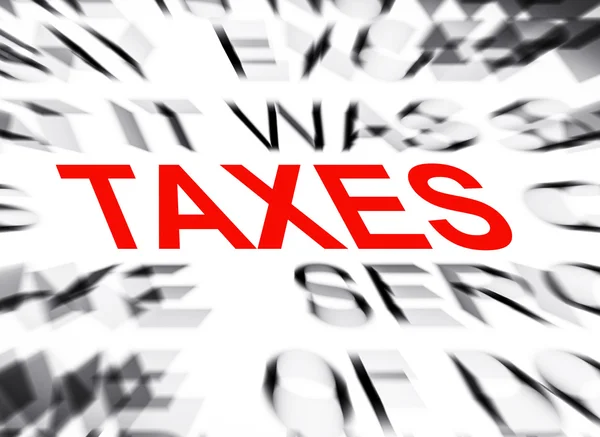 Blured tekst met focus op belastingen — Stockfoto