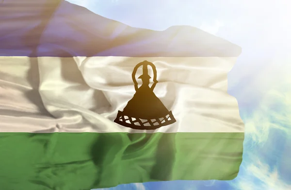 Lesotho zwaaien vlag tegen blauwe hemel met zonnestralen — Stockfoto