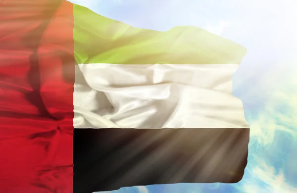 Vereinigte Arabische Emirate schwenken Flagge gegen blauen Himmel mit Sonnenstrahlen — Stockfoto