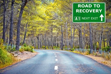 ROAD TO RECOVERY road sign against clear blue sky clipart