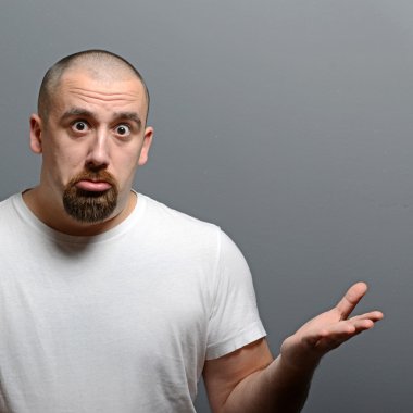 Portrait of a confused man against gray background clipart