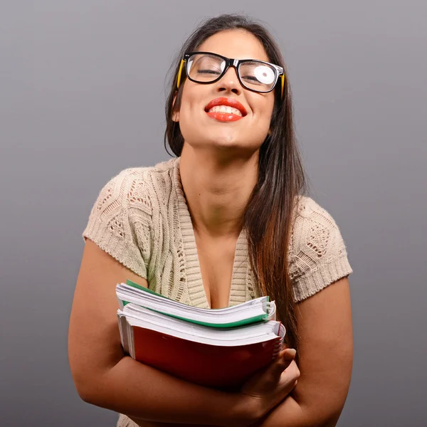 Portrait of happy student woman holding books with thumb up agai — Stock Photo, Image