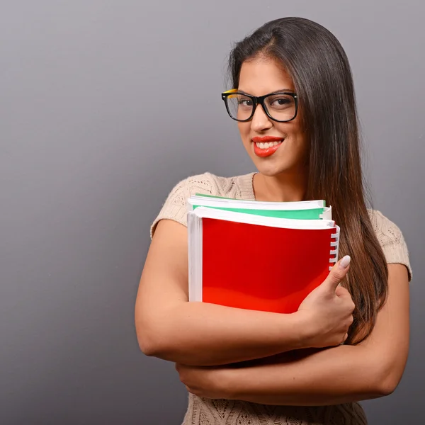Portrait of happy student woman holding books with thumb up agai — Stock Photo, Image