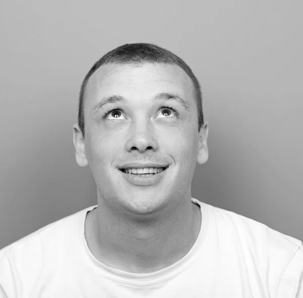 Portrait of happy young man looking up — Stock Photo, Image