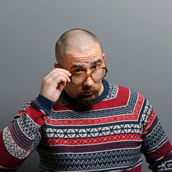 Retrato de un nerd con gafas y suéter retro contra gris b —  Fotos de Stock