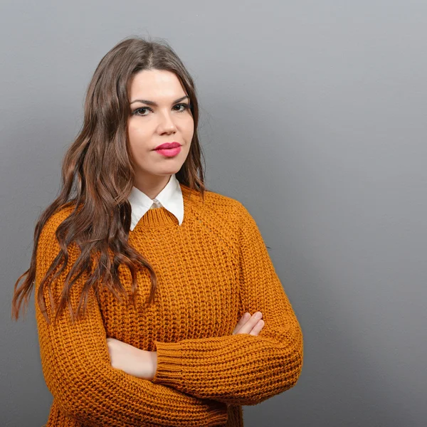 Retrato de una mujer confiada sonriente sobre fondo gris — Foto de Stock