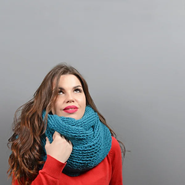Portrait of young thoughtful woman in winter clothes looking up — Stock Photo, Image
