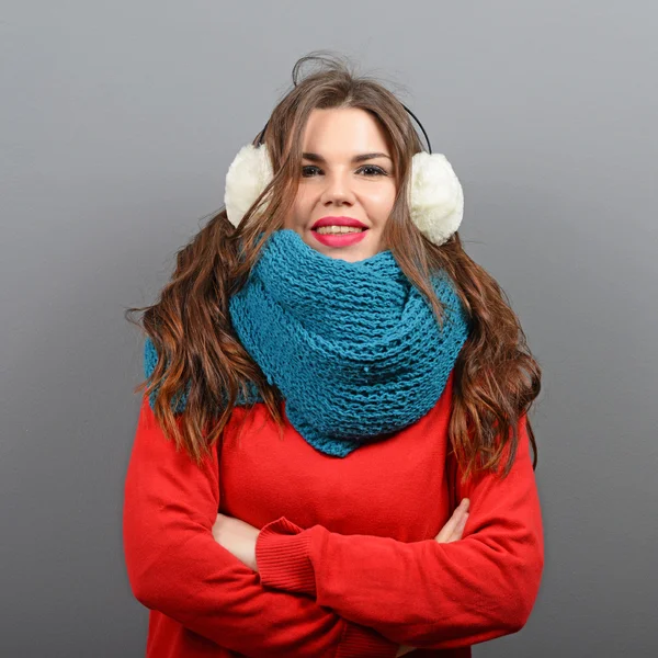 Portrait of young beautiful woman in winter clothes against gray — Stock Photo, Image