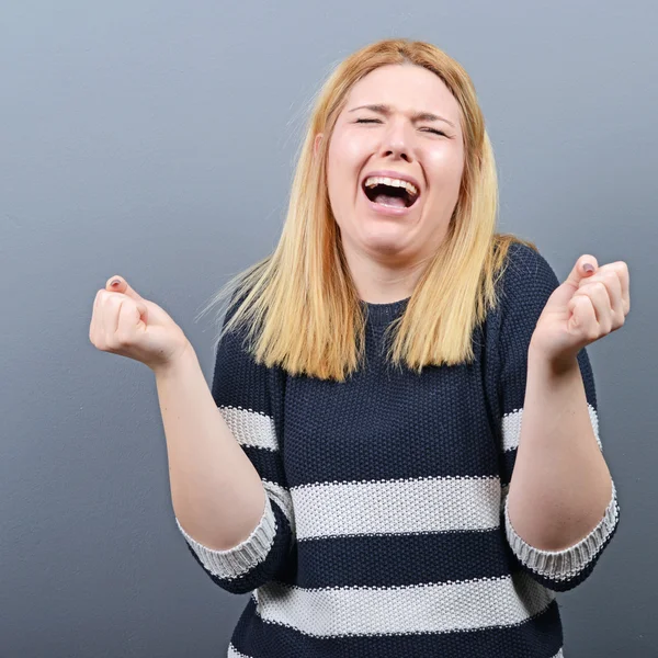 Desperate woman begging for mercy against gray background — Stock Photo, Image