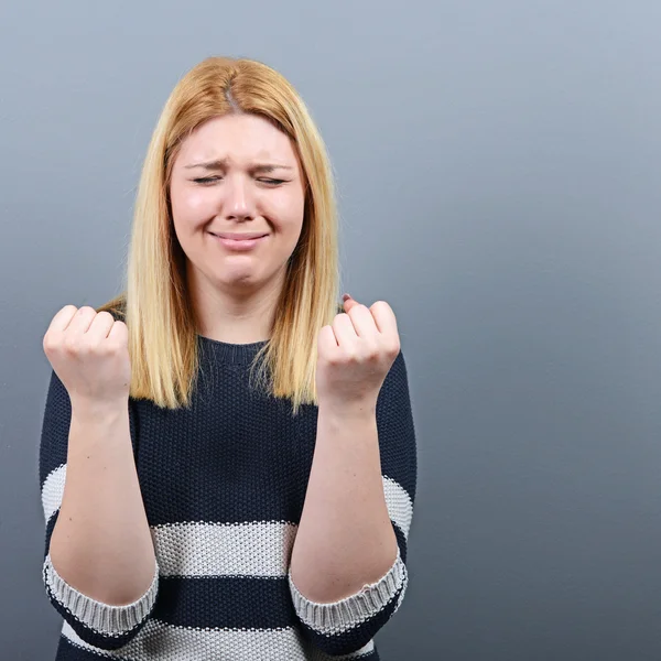 Desperate woman begging for mercy against gray background — Stock Photo, Image