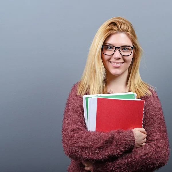 Portrait of happy student woman holding books with thumb up agai — Stock Photo, Image