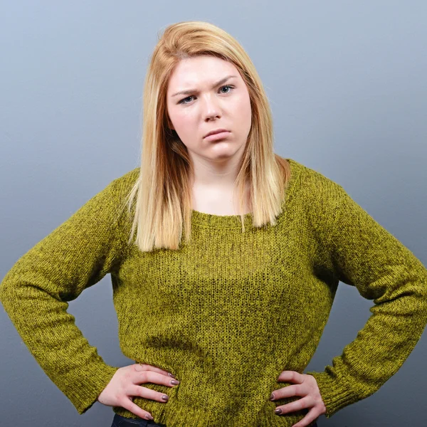 Portrait of mad woman against gray background — Stock Photo, Image