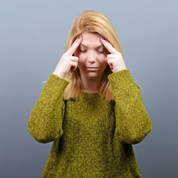 Porträt einer Frau, die sich vor grauem Hintergrund konzentriert — Stockfoto