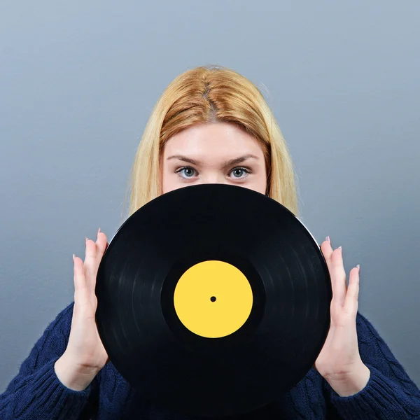 Woman dj portrait with vinyl record against gray background — Stock Photo, Image