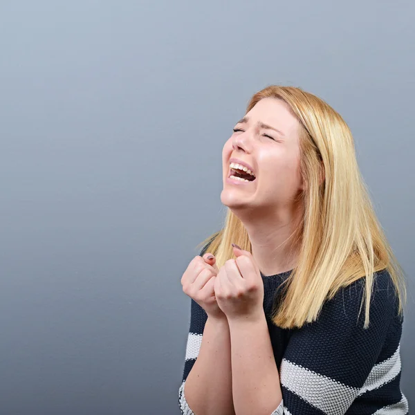 Woman praying about something or begging for mercy against gray — Stock Photo, Image