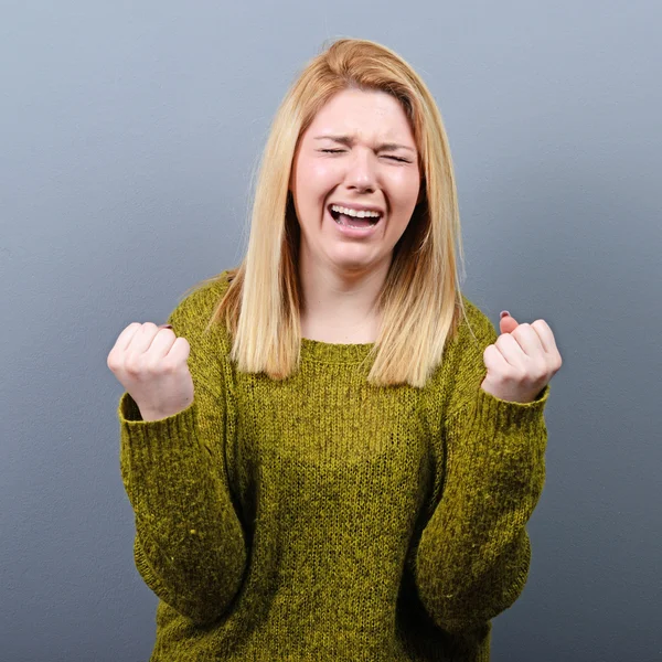 Woman praying about something or begging for mercy against gray — Stock Photo, Image