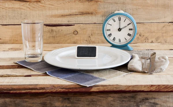 Retro alarm clock on a plate — Stock Photo, Image