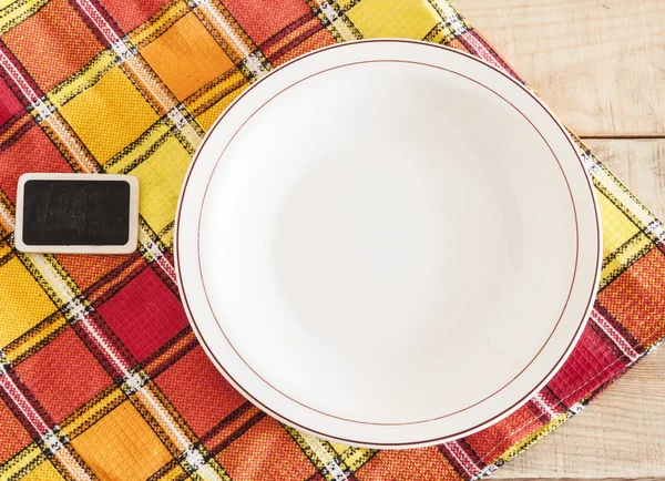 Letrero en blanco con plato blanco vacío en la mesa de madera —  Fotos de Stock