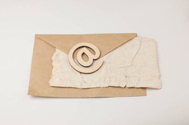 Kahverengi bir zarfın üzerindeki e-posta yazısında beyaz bir zemin üzerinde buruşmuş eski kağıt levha var. E- posta iletisinin konsepti