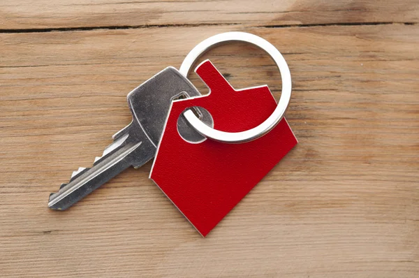 A key in a lock with house icon on it — Stock Photo, Image