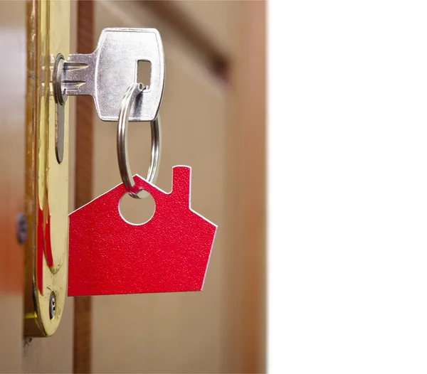 Símbolo da casa e enfiar a chave na fechadura — Fotografia de Stock