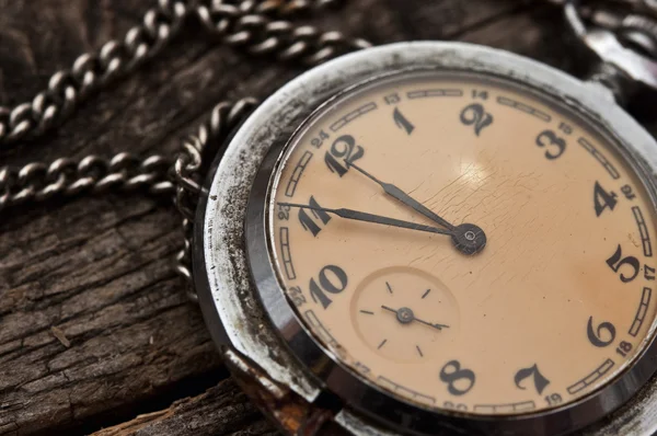 Old pocket watch on a rustic vintage wooden background — Stock Photo, Image