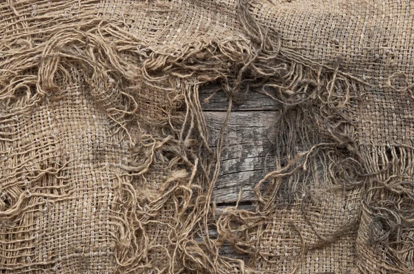 Background of burlap with a hole for writing text. texture of th — Stock Photo, Image