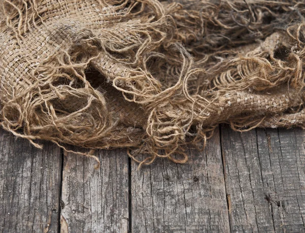 Burlap texture on wooden table background — Stock Photo, Image