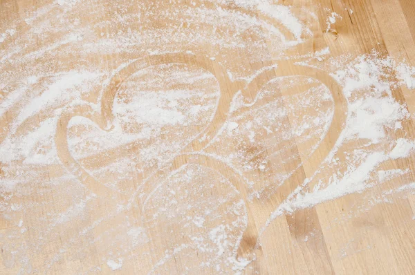 Heart on desk and flour — Stock Photo, Image