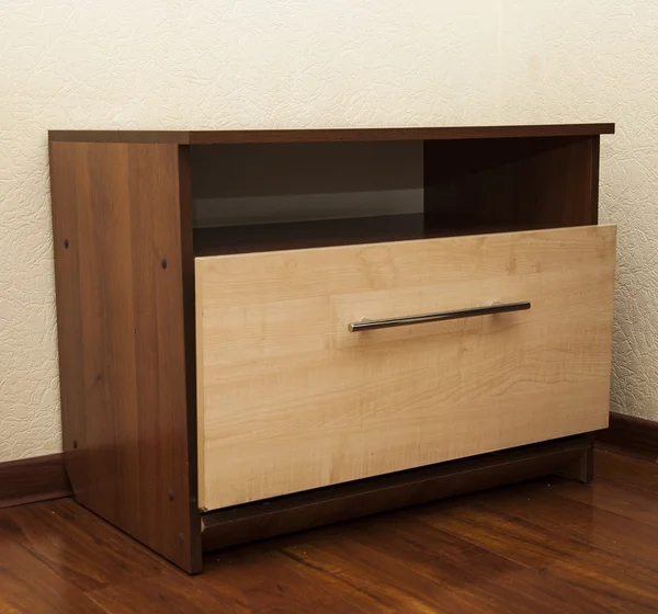 Modern wooden nightstand on the floor in bedroom — Stock Photo, Image