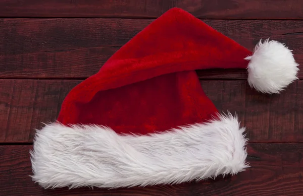 Santa hat on wooden table — Stock Photo, Image