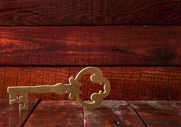 Old key on a wooden background