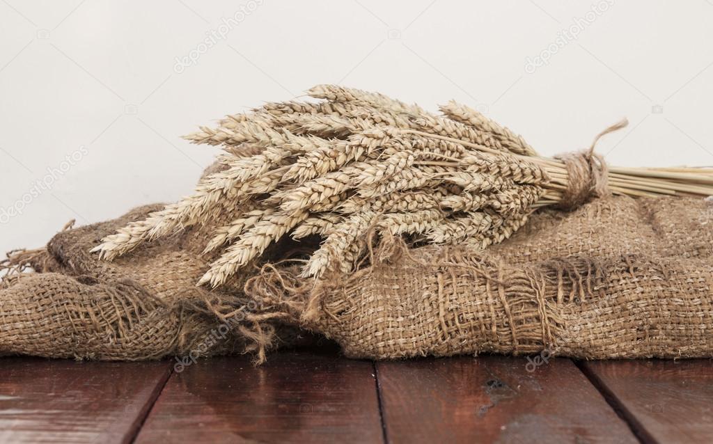 Bunch of ripe wheat on wooden table