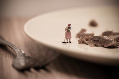 Miniature Housemaid Washing Dishes. Macro photo clipart