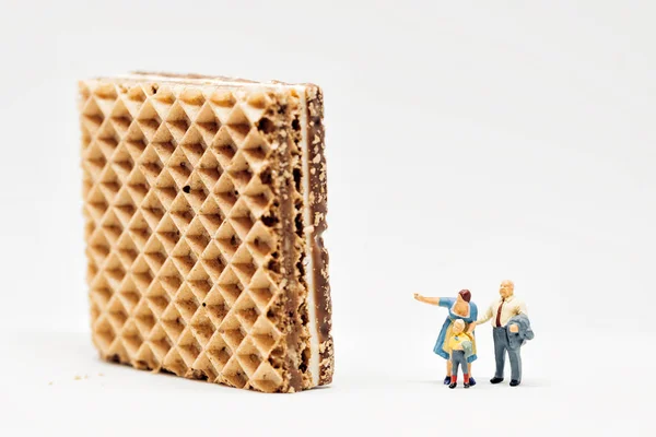 Miniature People Two Adults Showing Giant Waffle Boy — Stock Photo, Image