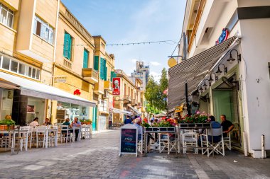 NICOSIA, CYPRUS - MAY 29:  People enjoying a summer in cafes at Onasagorou street in central Nicosia, Cyprus. clipart