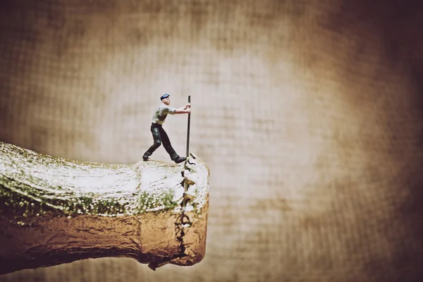 Miniature worker opening a beer bottle. Color tone tuned photo — Stock Photo, Image