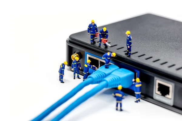 Team of technicians connecting network cable — Stock Photo, Image