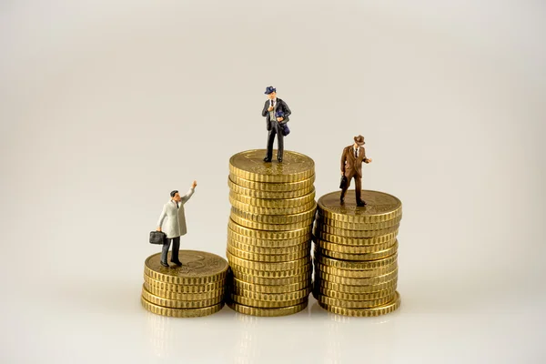 Businessman on the top of coins stack — Stock Photo, Image