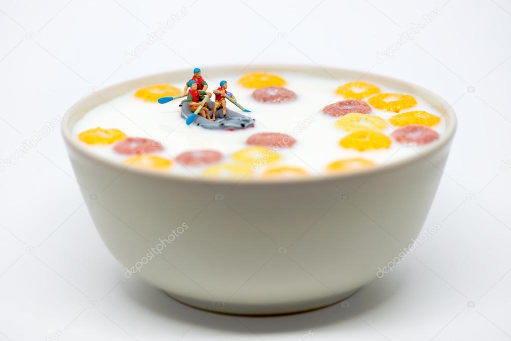 Rafting in a bowl of colorful cereal with milk. Healthy breakfas