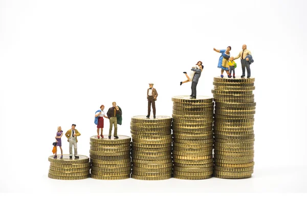 Faily budget concept. Miniature family on coins pile. — Stock Photo, Image