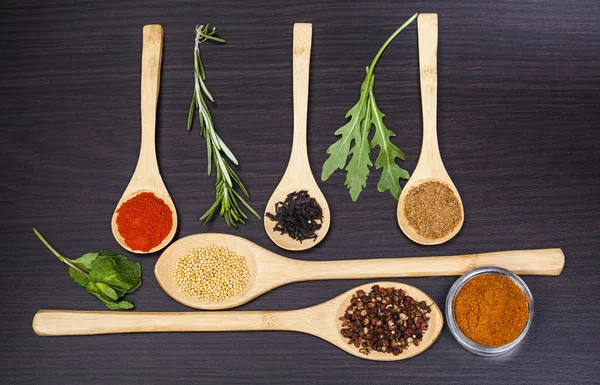 Colorful spices and wooden cutlery — Stock Photo, Image